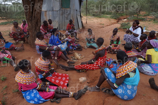 On 13th January 2016, (wearing white) volunteer Elizabeth Lemoyog speaks during a womens public gathering and dialogue forum in Kiltamany village located in Waso ward, Archers post Samburu East Sub County in Samburu County. The public gathering and dialogue forum was facilitated by UNICEF and PCF. In this forum women stand up and said NO to FGM/C and child marriage. They suggested every women to approach men of their family regarding on FGM/C and child marriage so they have solutions without conflicting with their community men including brothers and husbands. UNICEF and Pastoralist Child Foundation programme on accelerating abandonment of Female genital Mutilation/Cutting (FGM/C) and Child marriage in six villages of Waso ward in Archers Post-Samburu county through community mobilization, education, inter-generational dialogue and capacity development of duty bearers.